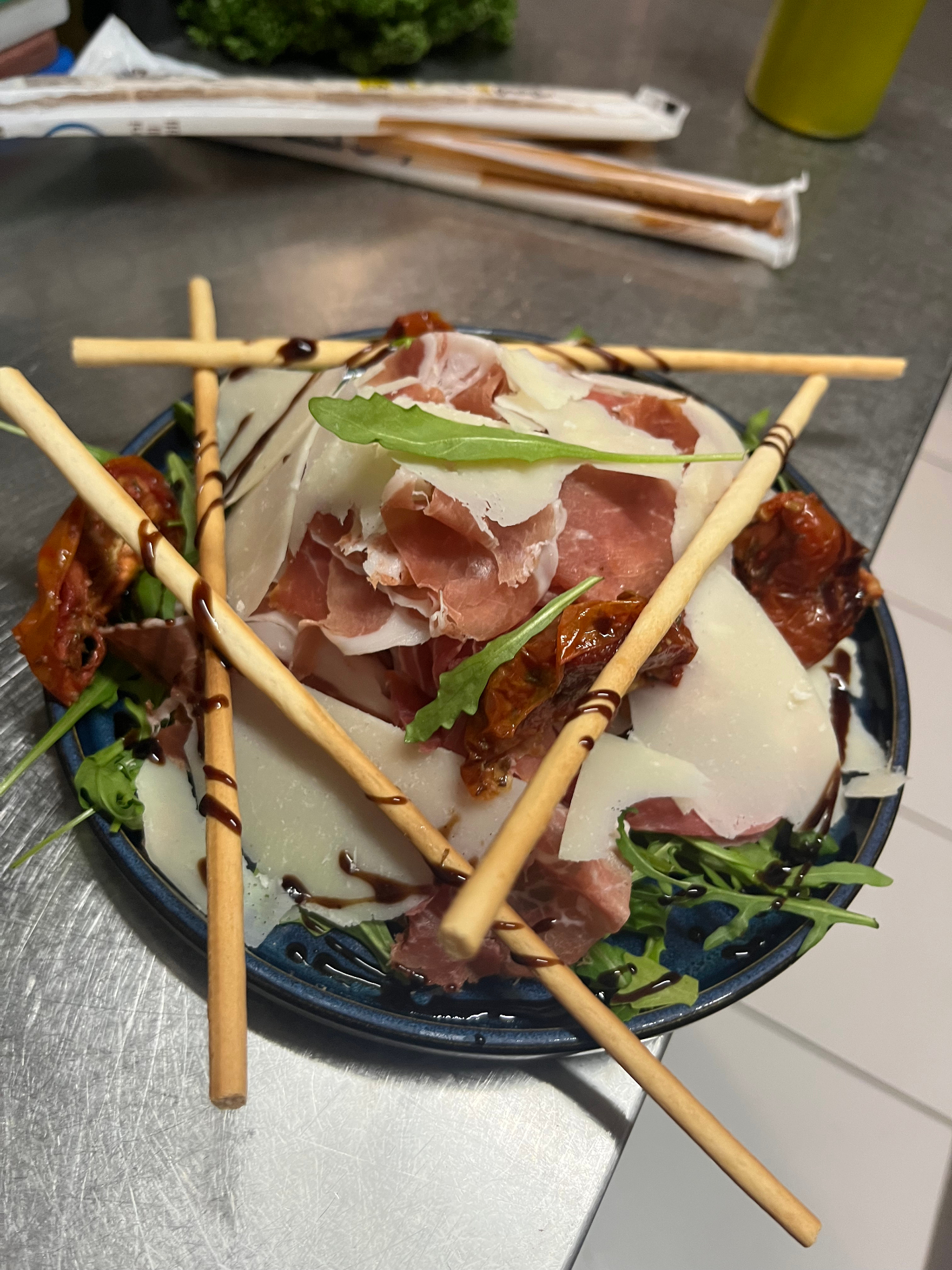 Antipasto de jambon cru, grana Padano, tomates confites et grissini au vinaigre balsamique